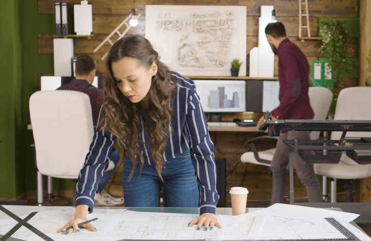 beautiful caucasian designer working blueprints modern cozy office 2